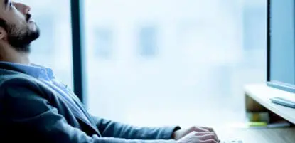 Man frustrated while working on computer