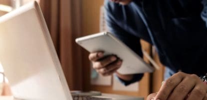 Man using ipad and laptop