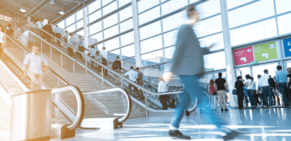 people going up escalator and walking quickly