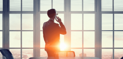 CFO talking on phone in front of window